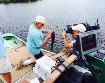 Bill Dance doing TV show with Capt Mike.