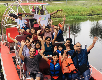 group of happy people on an airboat tour